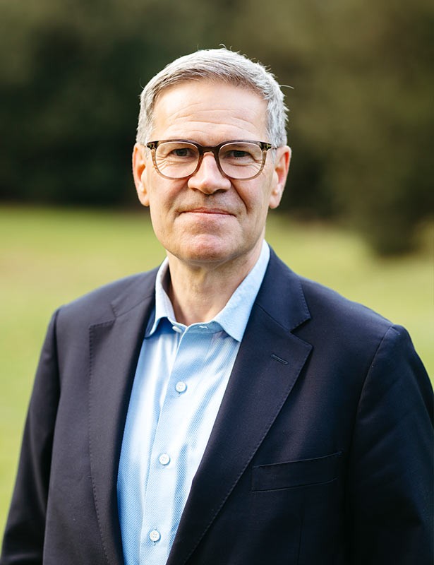 Mann mit Brille im Anzug im Park